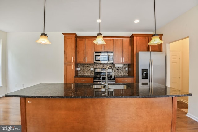 1910 Scaffold Way, Odenton, MD 21113 - kitchen featuring appliances with stainless steel finishes, a sink, wood finished floors, backsplash, and brown cabinets