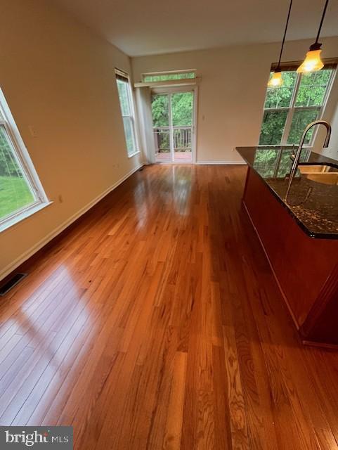 1910 Scaffold Way, Odenton, MD 21113 - unfurnished living room featuring a sink, wood finished floors, and healthy amount of natural light