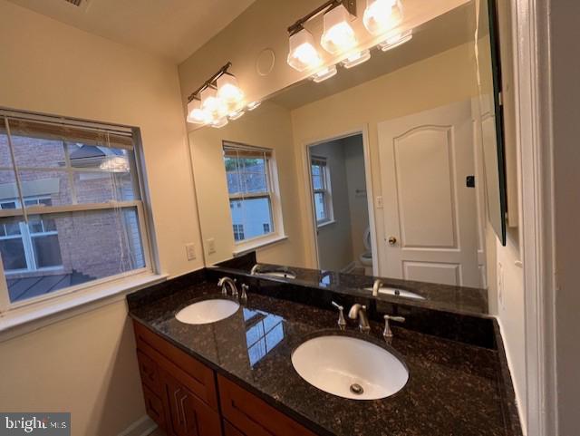 1910 Scaffold Way, Odenton, MD 21113 - bathroom with double vanity, toilet, baseboards, and plenty of natural light