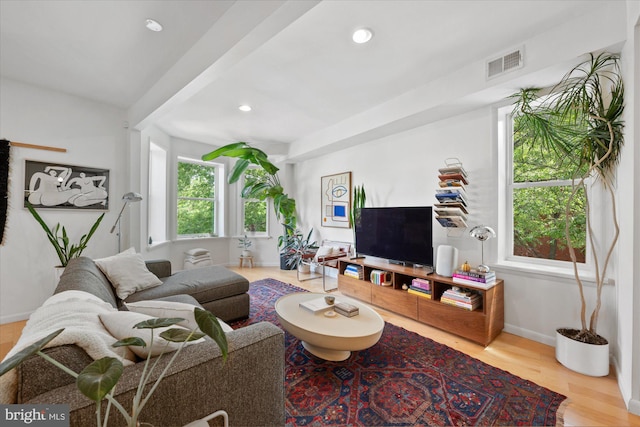 living room with baseboards, wood finished floors, and recessed lighting