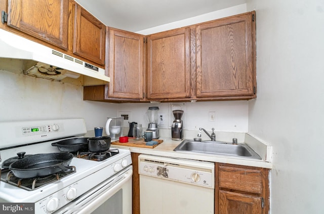 922 24th St NW Unit 313, Washington, DC 20037 - kitchen with white appliances, under cabinet range hood, light countertops, and brown cabinets