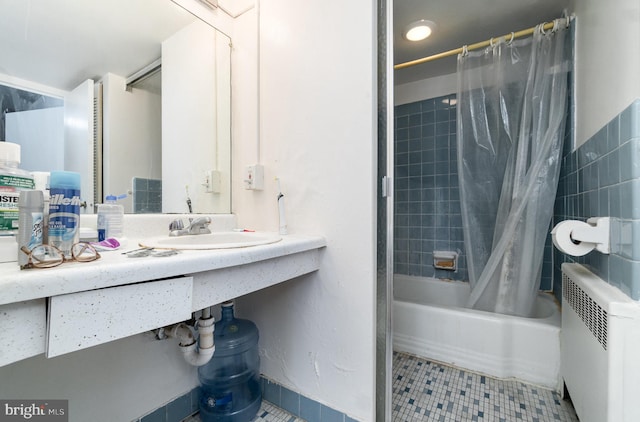 922 24th St NW Unit 313, Washington, DC 20037 - bathroom with radiator, tile patterned flooring, and shower / tub combo with curtain