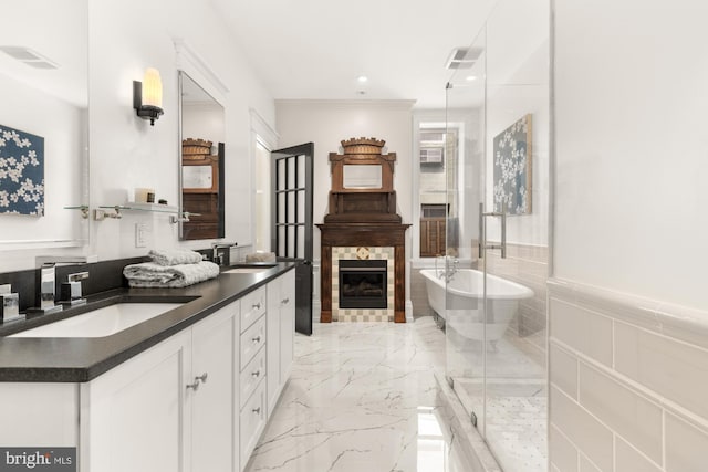 1519 Kingman Pl NW, Washington, DC 20005 - bathroom featuring double vanity, marble tiled flooring, a soaking tub, a stall shower, and a glass covered fireplace