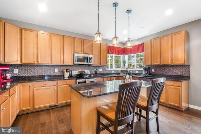 6218 Alan Linton Blvd W, Frederick, MD 21703 - kitchen featuring stainless steel appliances, dark wood-type flooring, a kitchen bar, a center island, and recessed lighting
