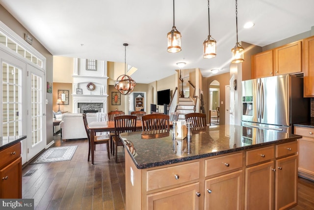 6218 Alan Linton Blvd W, Frederick, MD 21703 - kitchen with stainless steel fridge with ice dispenser, open floor plan, a fireplace, dark wood-type flooring, and hanging light fixtures