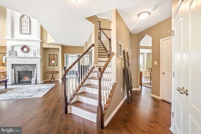 6218 Alan Linton Blvd W, Frederick, MD 21703 - stairway with arched walkways, wood-type flooring, baseboards, and a stone fireplace