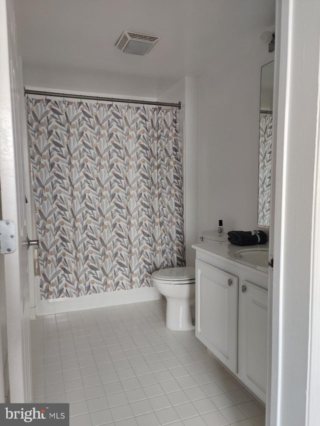 bathroom with tile patterned floors, vanity, toilet, and a shower with curtain