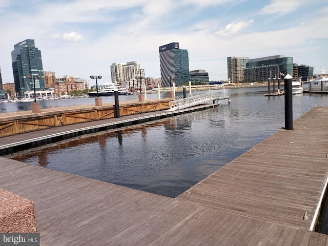 dock featuring a view of city and a water view