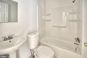 full bathroom featuring toilet, a sink, and tub / shower combination