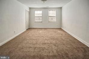 unfurnished room with carpet floors and baseboards