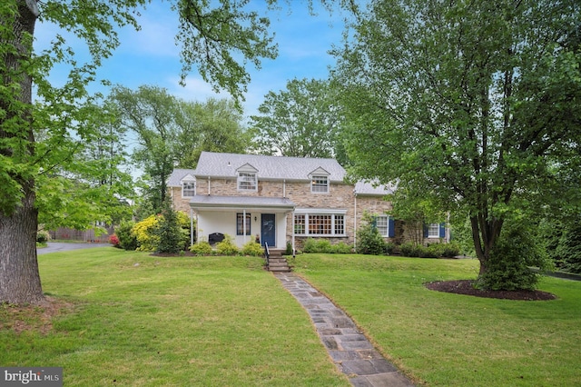 view of front of property with stone siding and a front yard