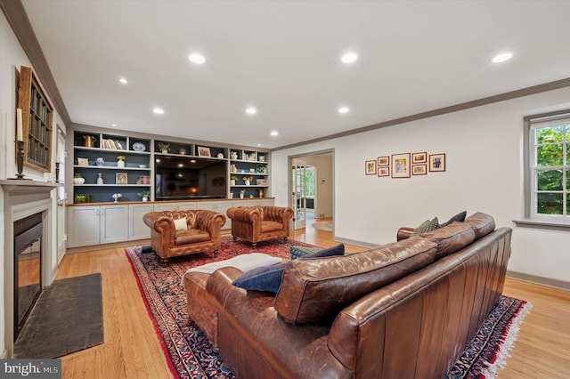 living room featuring crown molding, a fireplace, light wood finished floors, recessed lighting, and baseboards