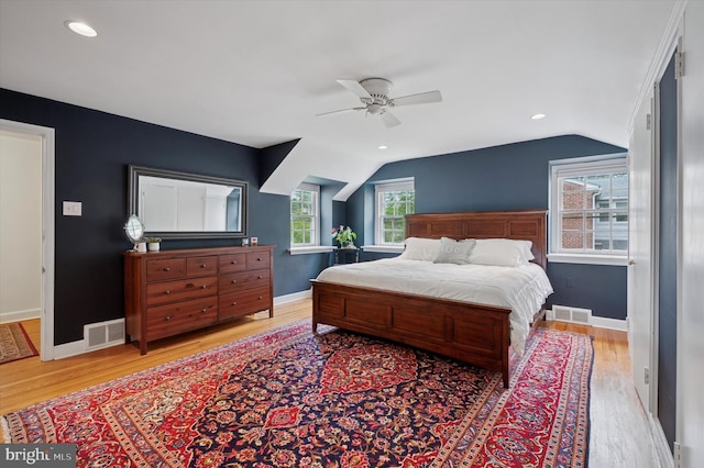 bedroom featuring vaulted ceiling, wood finished floors, baseboards, and a ceiling fan
