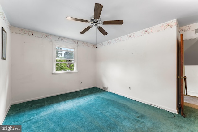 empty room with carpet, ceiling fan, and baseboards