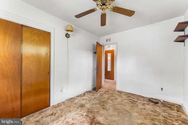 spare room featuring carpet, a ceiling fan, and baseboards