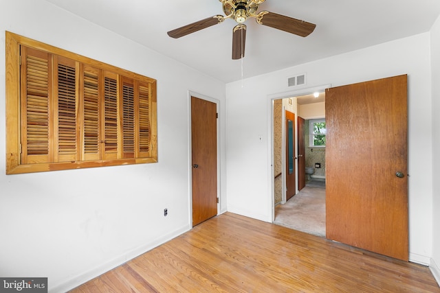 unfurnished bedroom featuring wood finished floors, baseboards, and ceiling fan