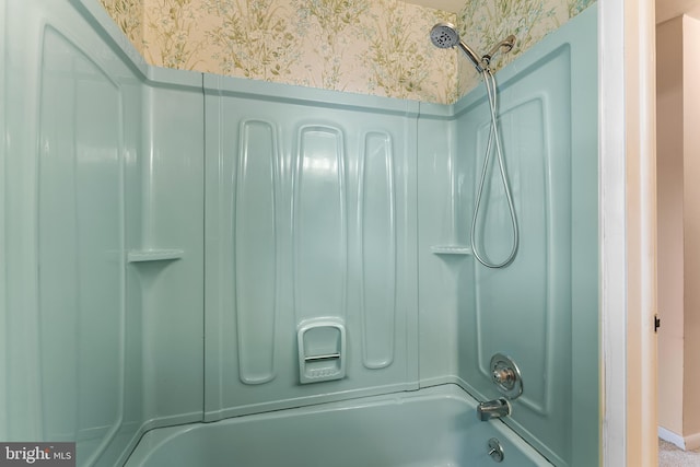 bathroom featuring wallpapered walls and  shower combination
