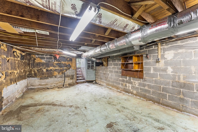 unfinished below grade area featuring stairway