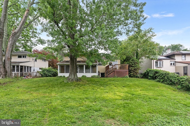 view of yard featuring a sunroom, stairs, and a deck