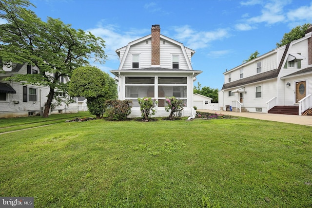 237 Roland Rd, Brookhaven, PA 19015 - back of house with a chimney, a sunroom, and a yard