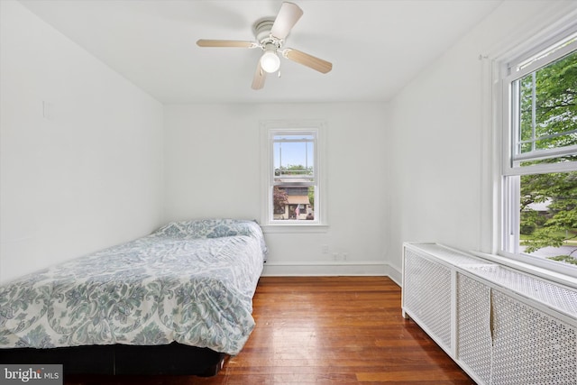 237 Roland Rd, Brookhaven, PA 19015 - bedroom featuring radiator heating unit, multiple windows, wood-type flooring, and baseboards