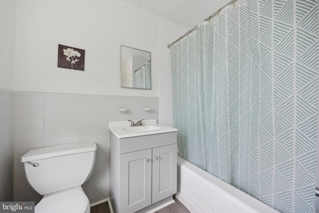 237 Roland Rd, Brookhaven, PA 19015 - full bathroom featuring toilet, tile walls, vanity, shower / tub combo, and a wainscoted wall