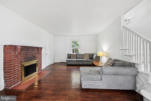 237 Roland Rd, Brookhaven, PA 19015 - living room featuring a baseboard heating unit, hardwood / wood-style flooring, a brick fireplace, and stairway