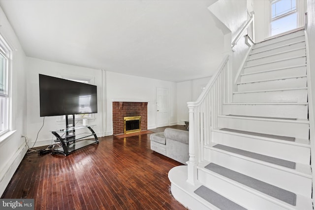 237 Roland Rd, Brookhaven, PA 19015 - living area with stairway, healthy amount of natural light, hardwood / wood-style floors, and a brick fireplace
