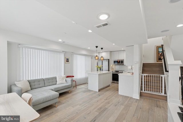 1325 N 17th St Unit A, Philadelphia, PA 19121 - living area featuring light wood-style flooring, stairway, and recessed lighting