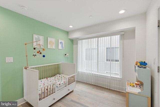 1325 N 17th St Unit A, Philadelphia, PA 19121 - bedroom featuring hardwood / wood-style floors, a crib, baseboards, and recessed lighting