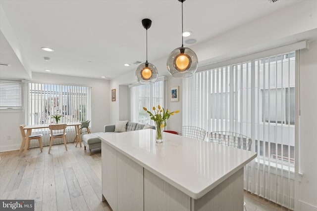 1325 N 17th St Unit A, Philadelphia, PA 19121 - kitchen featuring light wood-style flooring, a kitchen island, hanging light fixtures, baseboards, and recessed lighting