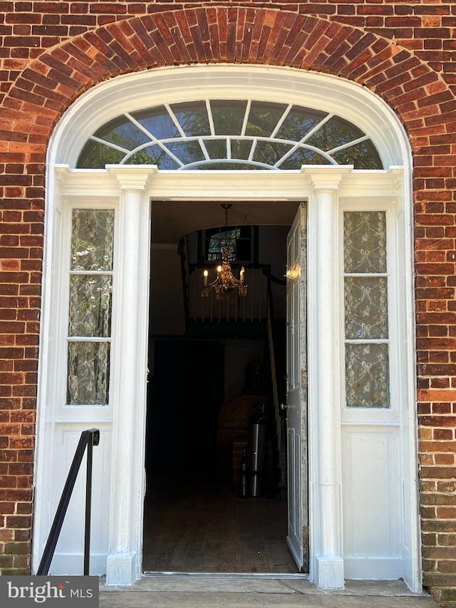 view of exterior entry featuring brick siding