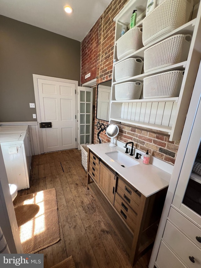 kitchen featuring a sink, dark wood-style flooring, open shelves, light countertops, and decorative backsplash