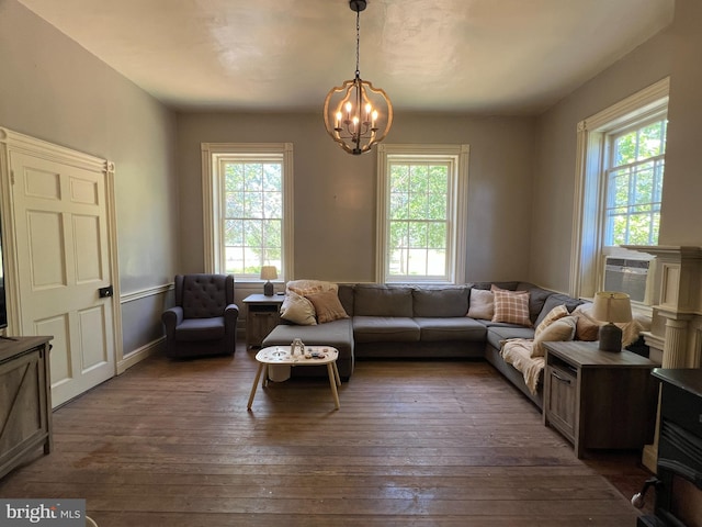 living room featuring plenty of natural light, a chandelier, dark wood finished floors, and cooling unit