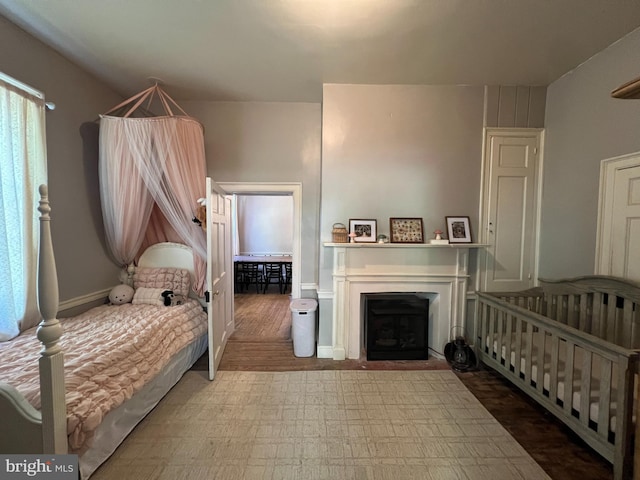 bedroom featuring a fireplace