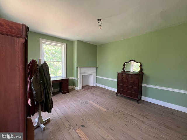 interior space featuring wood-type flooring and baseboards