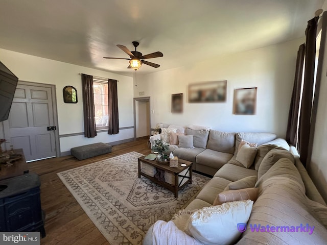 living area with a ceiling fan and wood finished floors