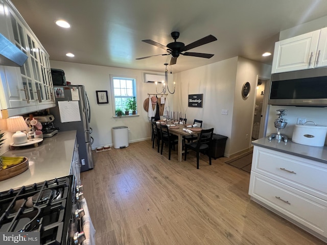 dining area featuring a ceiling fan, recessed lighting, light wood-style floors, a wall mounted air conditioner, and baseboards