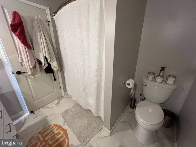 full bathroom with marble look tile flooring, a shower stall, toilet, and baseboards