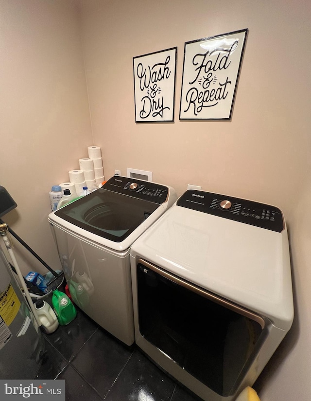 washroom with washer and dryer and tile patterned floors