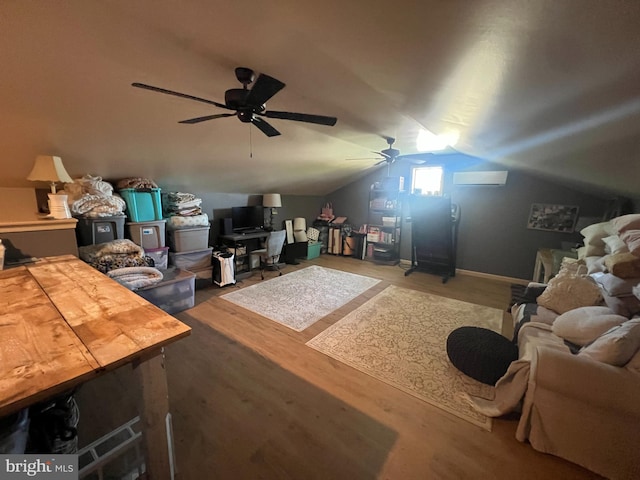 living area featuring ceiling fan, a desk, and vaulted ceiling