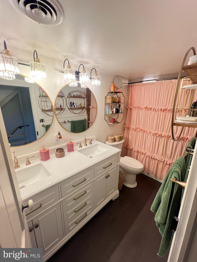 full bathroom featuring toilet, wood finished floors, double vanity, and shower / bathtub combination with curtain