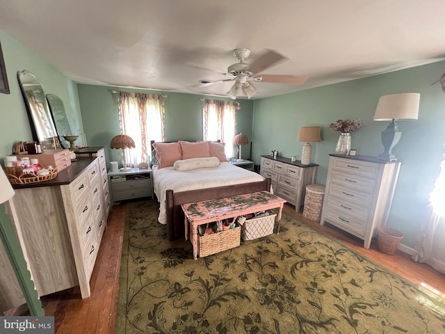 bedroom with dark wood finished floors and a ceiling fan