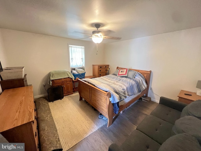 bedroom with light wood-type flooring, baseboards, and a ceiling fan