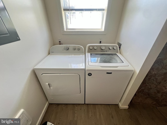 washroom featuring washer and clothes dryer, wood finished floors, and baseboards