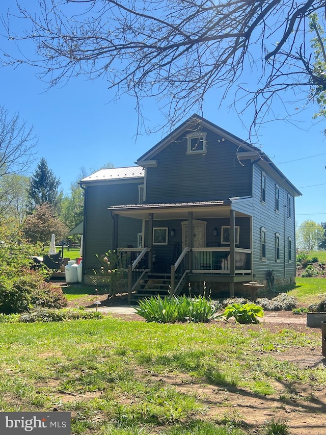 rear view of property with a porch and metal roof