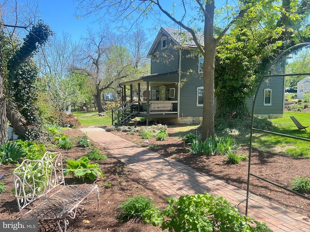 back of property with covered porch