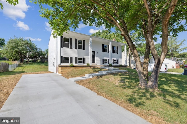 bi-level home with a front yard and a chimney