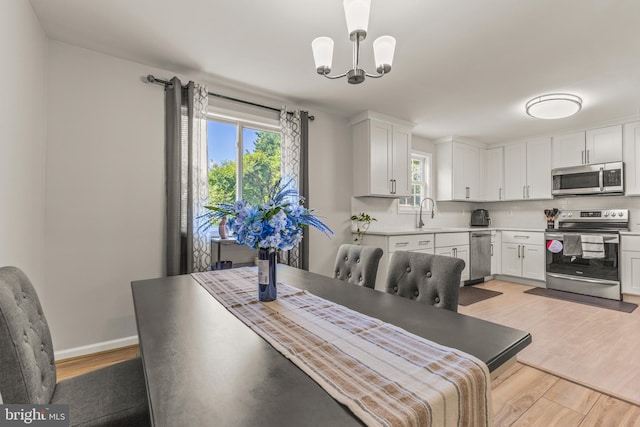 3607 Stonesboro Rd, Fort Washington, MD 20744 - dining room featuring light wood-type flooring, healthy amount of natural light, and a chandelier