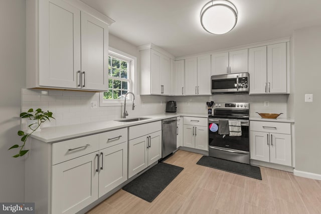 3607 Stonesboro Rd, Fort Washington, MD 20744 - kitchen with stainless steel appliances, a sink, white cabinets, light countertops, and decorative backsplash